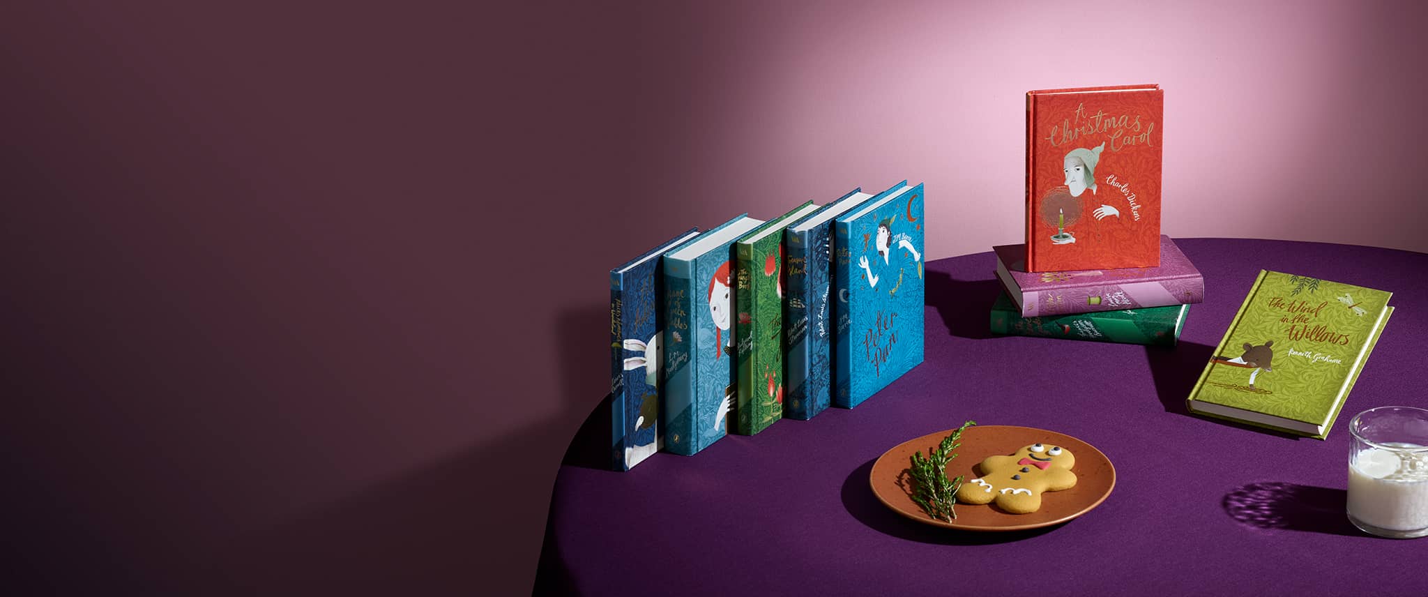 V&A Children's Classics on purple clothed table with gingerbread man and a glass of milk