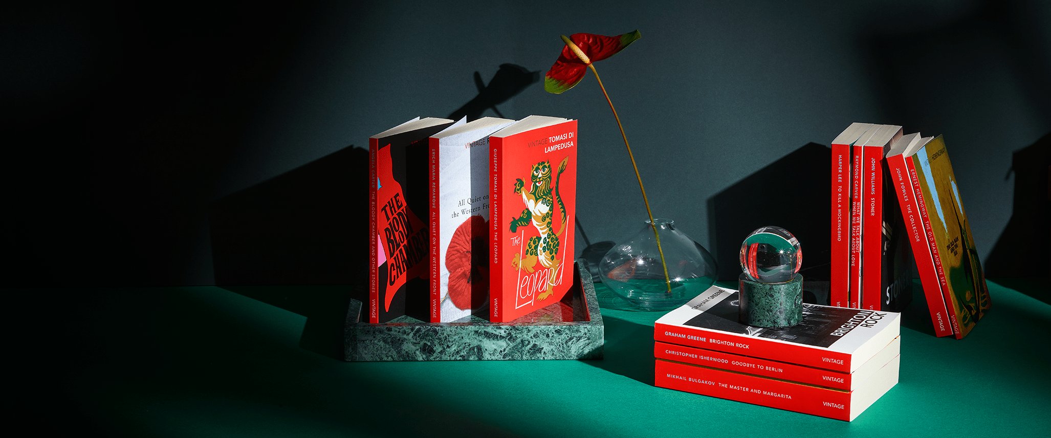 Vintage Classics on a green table with a vase and snow globe