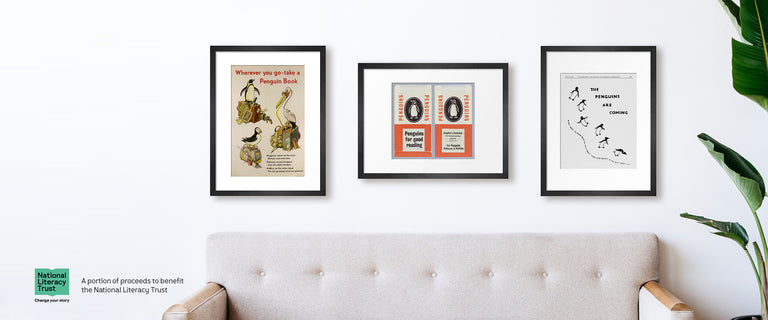 Three prints framed above a couch representing images from Penguin's design history.